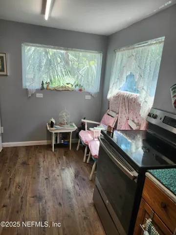a view of a dining room with furniture and a potted plant