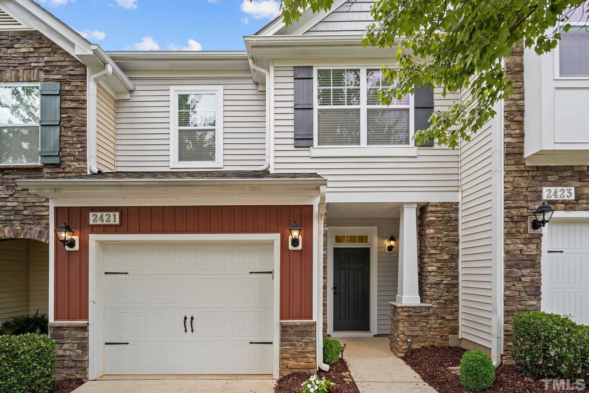 2421 Memory Ridge Drive Raleigh, NC 27606 - Photo 1 of 31 a front view of a house with a garage