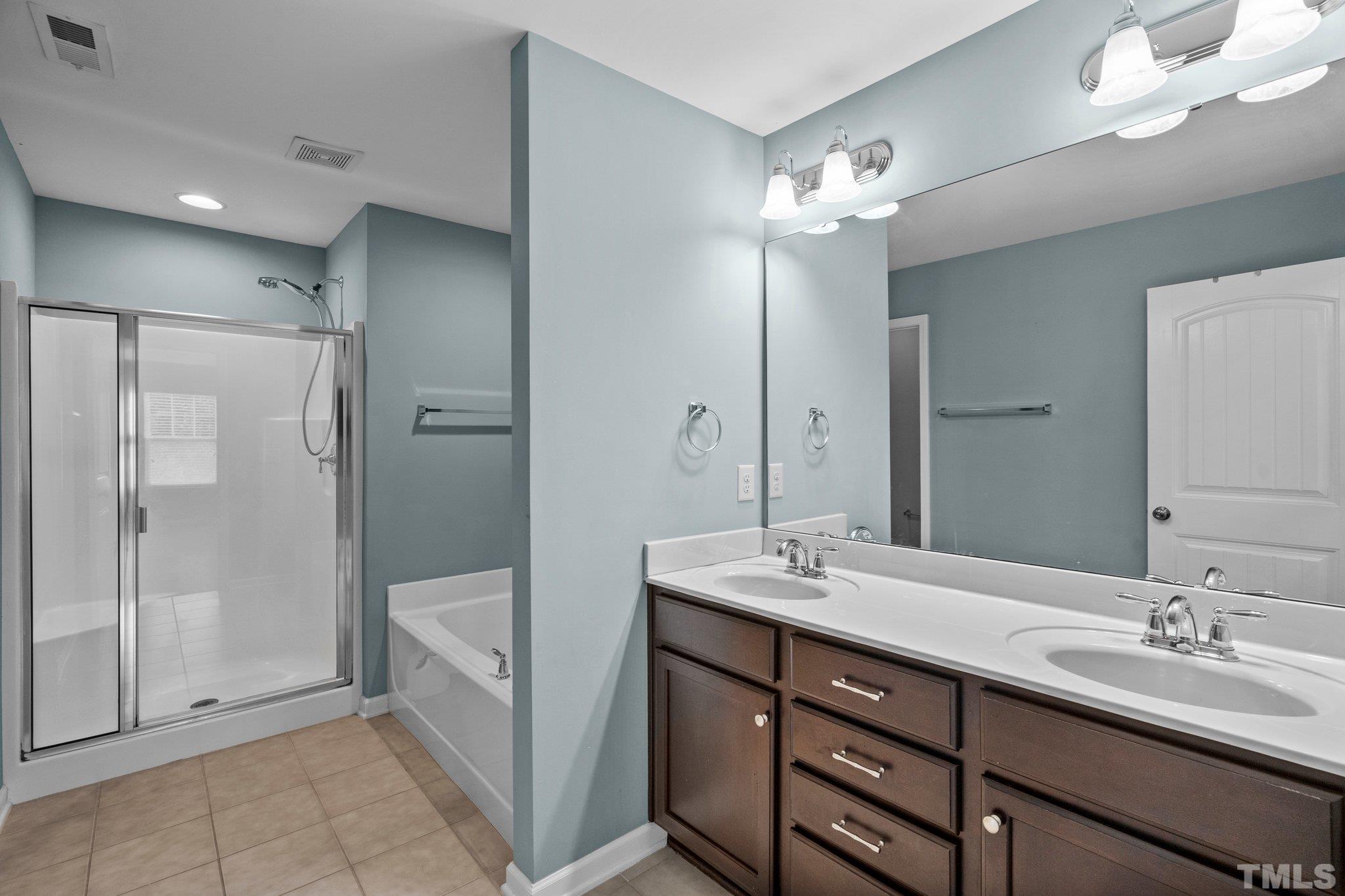 2421 Memory Ridge Drive Raleigh, NC 27606 - Photo 13 of 31 a spacious bathroom with a double vanity sink mirror and shower