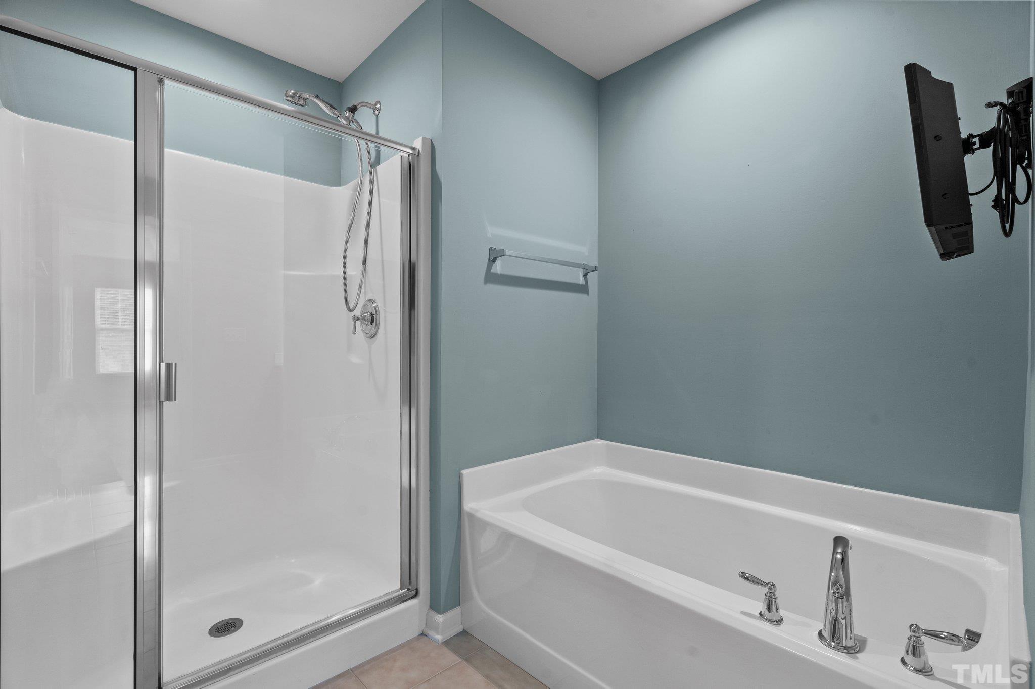 2421 Memory Ridge Drive Raleigh, NC 27606 - Photo 14 of 31 a bathroom with a bathtub and a shower