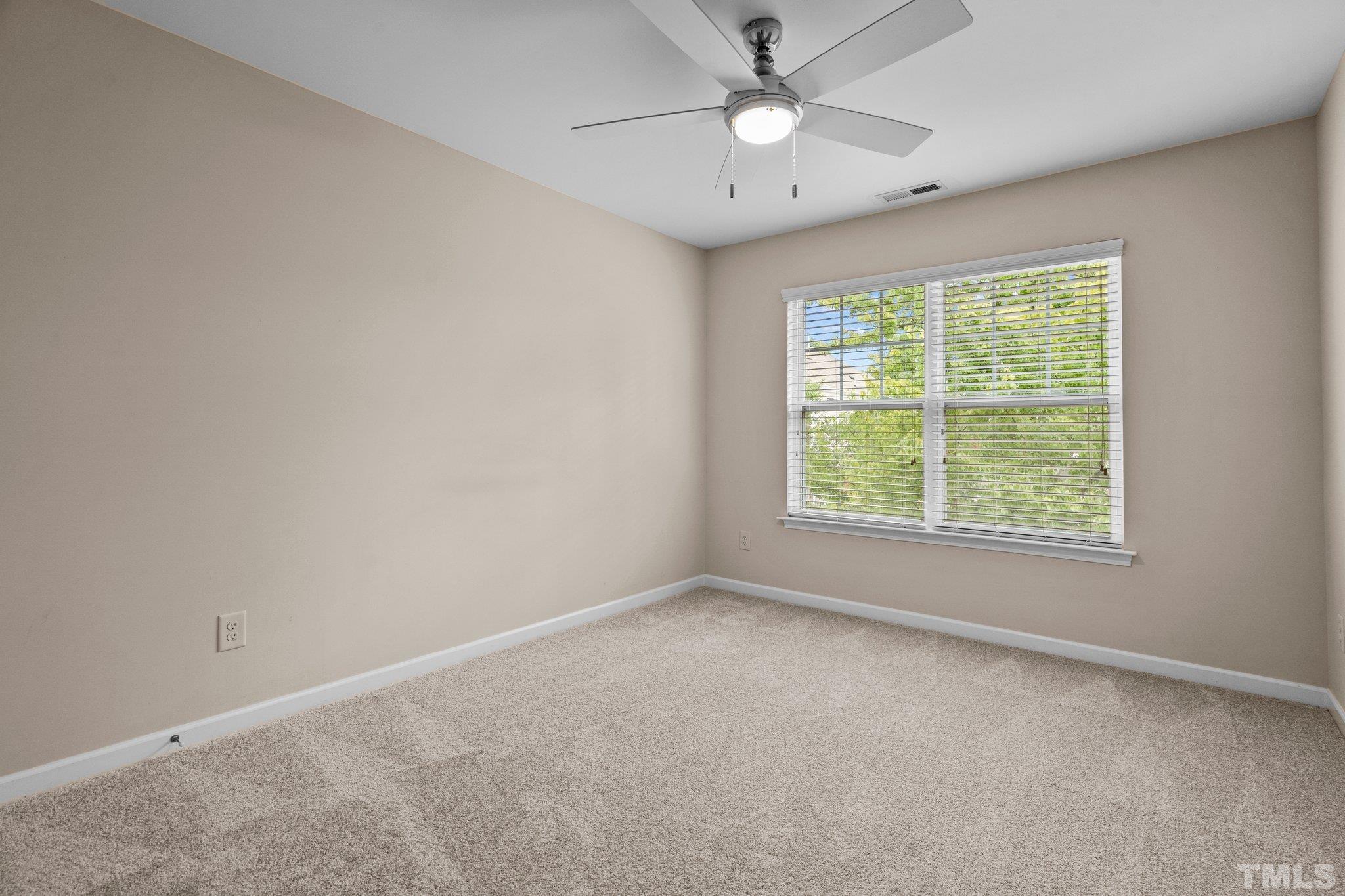 2421 Memory Ridge Drive Raleigh, NC 27606 - Photo 16 of 31 an empty room with a window and a fan