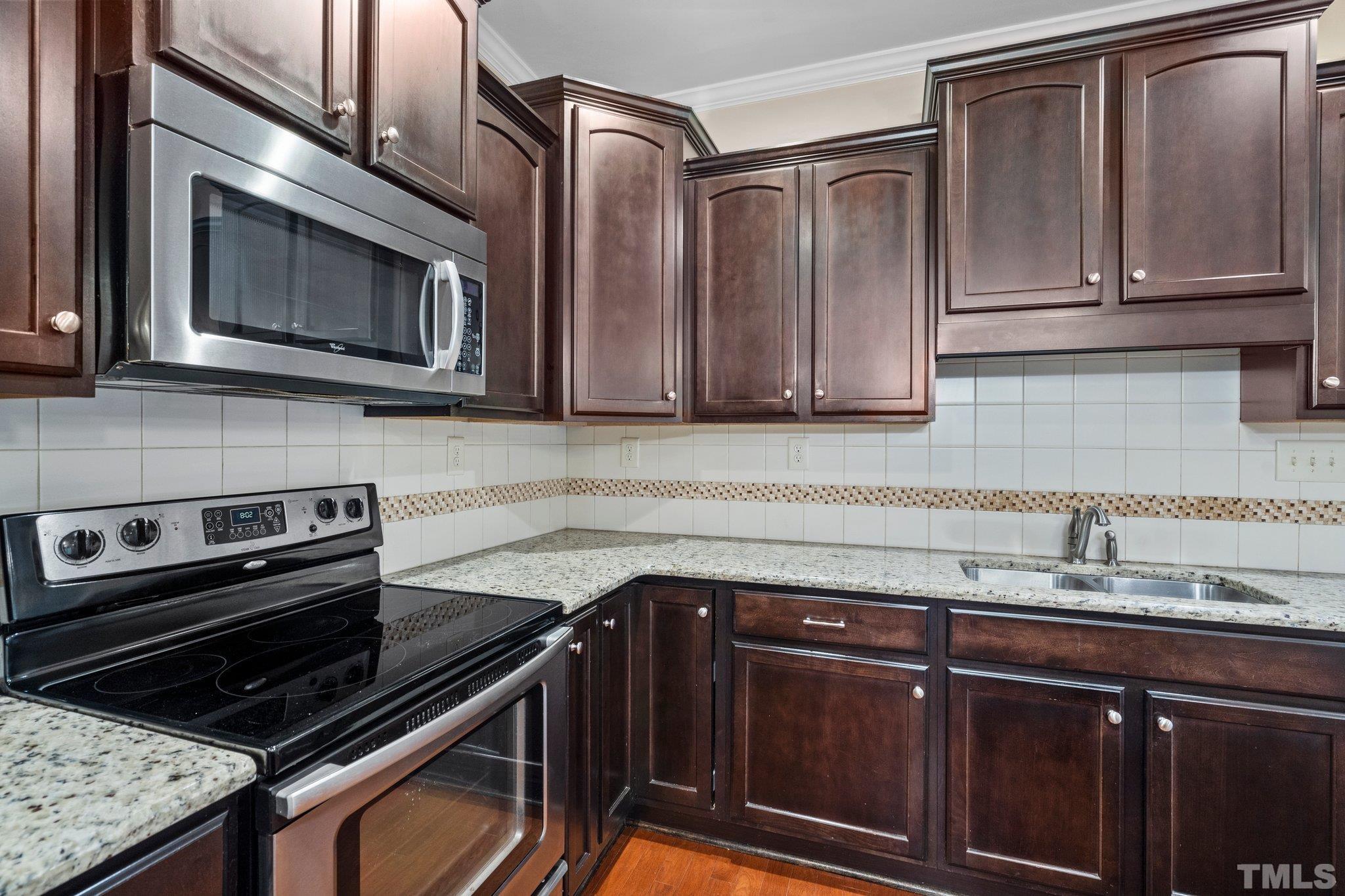 2421 Memory Ridge Drive Raleigh, NC 27606 - Photo 6 of 31 a kitchen with granite countertop cabinets and steel stainless steel appliances