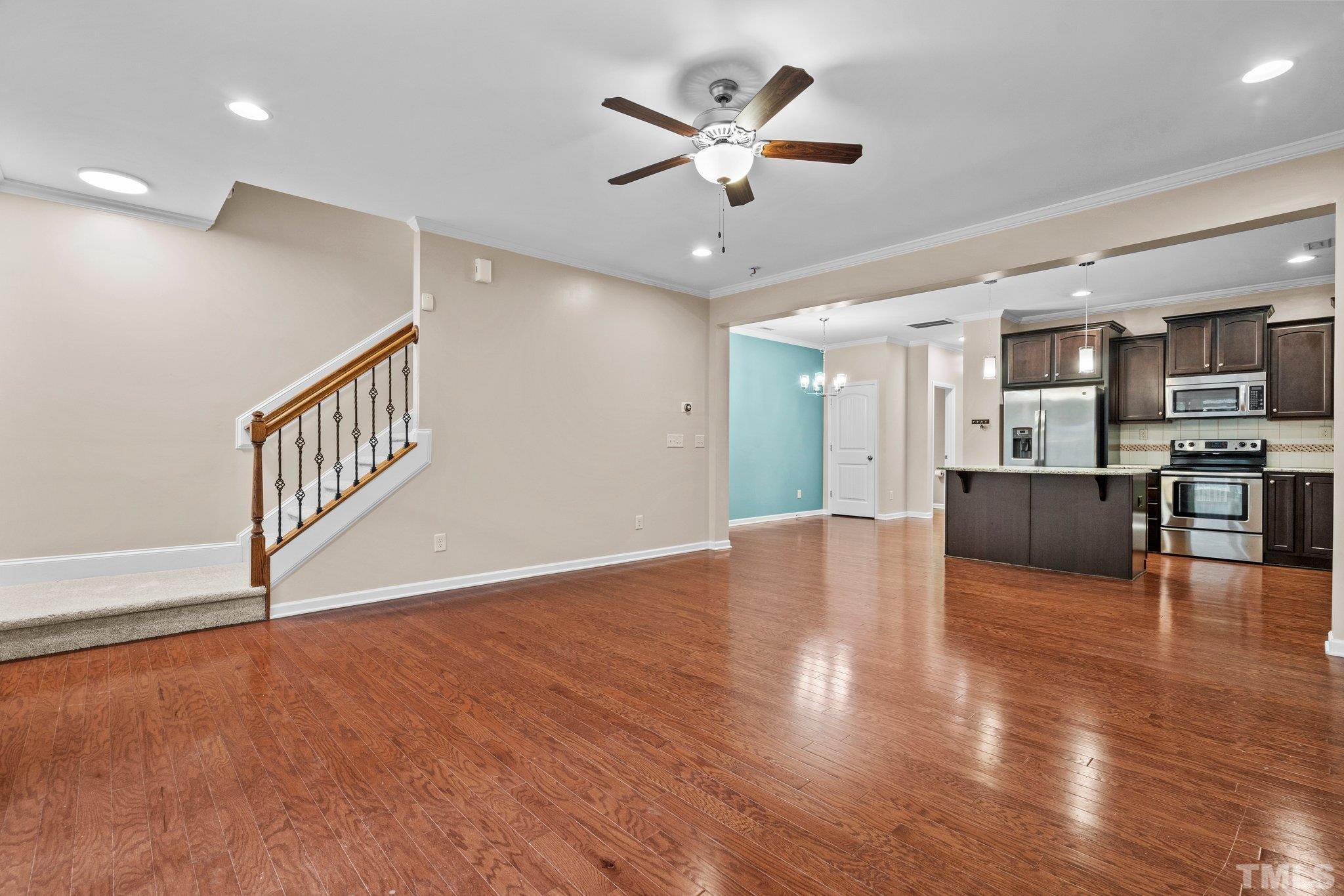 2421 Memory Ridge Drive Raleigh, NC 27606 - Photo 10 of 31 a view of an empty room with wooden floor and a ceiling fan