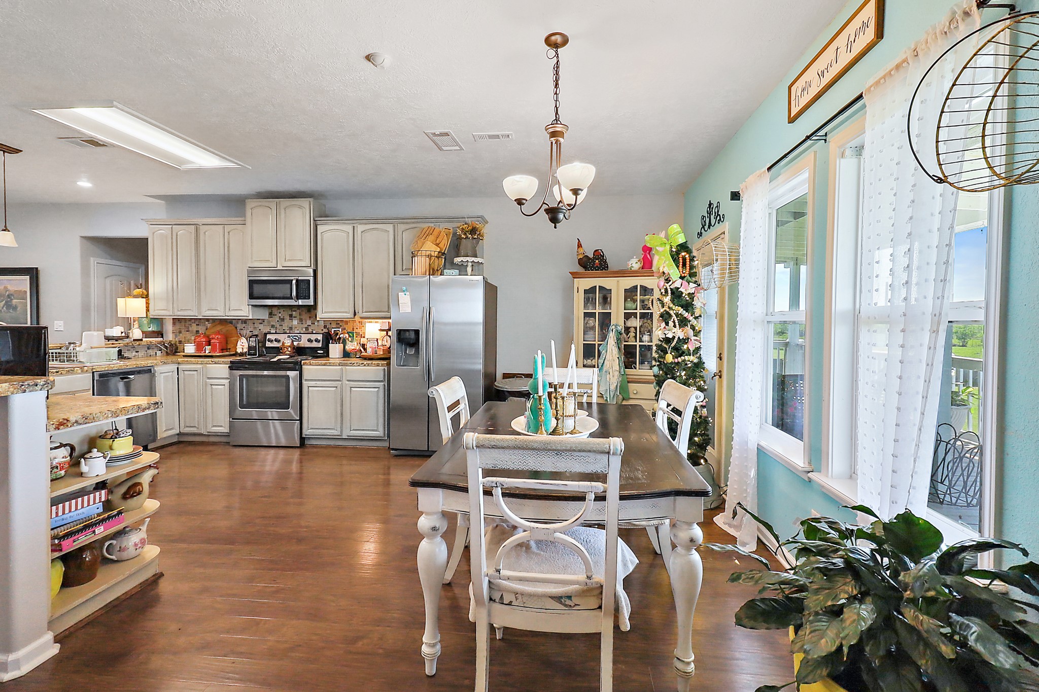 13659 Todd Road Winnie, TX 77665 - Photo 11 of 42 a view of a dining room and livingroom with furniture wooden floor a chandelier