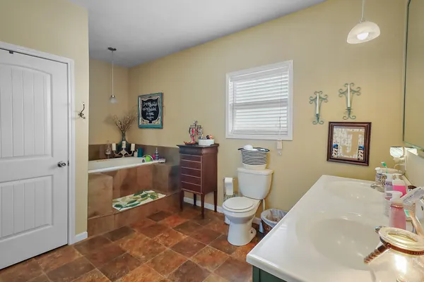 a spacious bathroom with a sink and a toilet