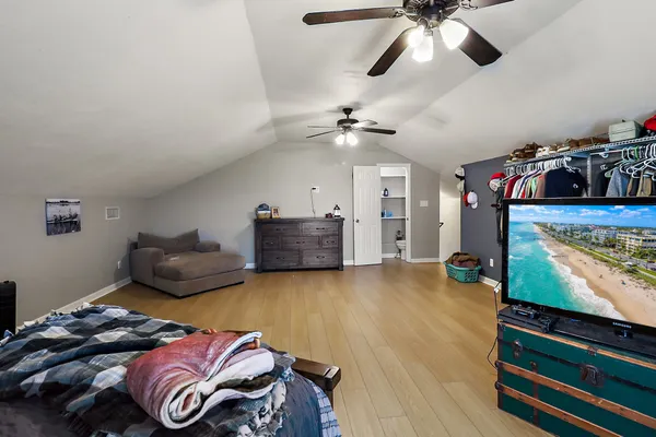 a bedroom with furniture and a flat screen tv