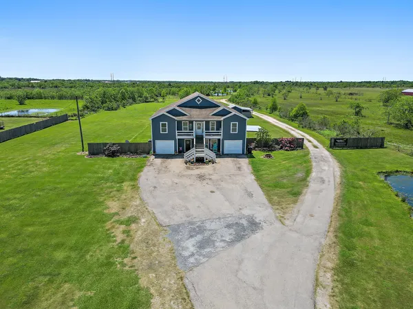 an aerial view of a house with a yard