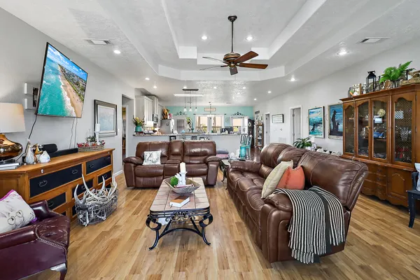 a living room with lots of furniture and kitchen view