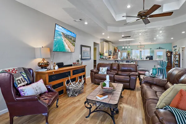 a living room with furniture a ceiling fan and a rug