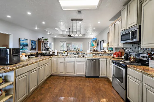 a kitchen with white cabinets stainless steel appliances and sink