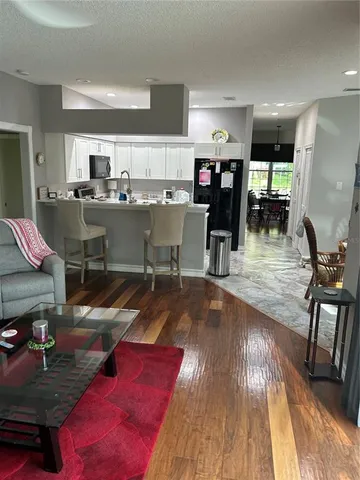 a living room with lots of furniture and kitchen view