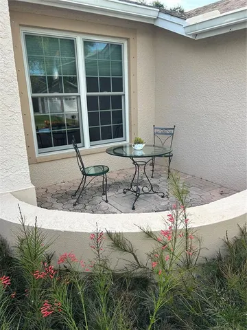a house with yard and outdoor seating