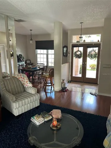 a living room with furniture and a chandelier