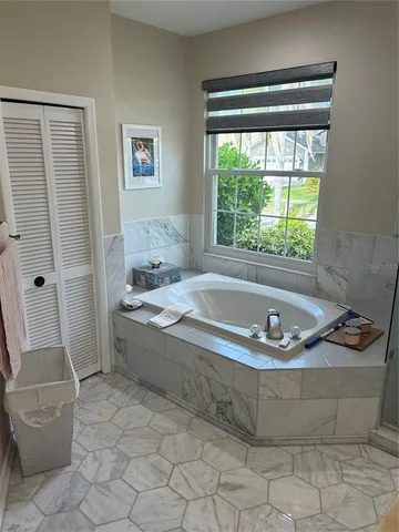 a bath tub sitting in a bathroom next to a window