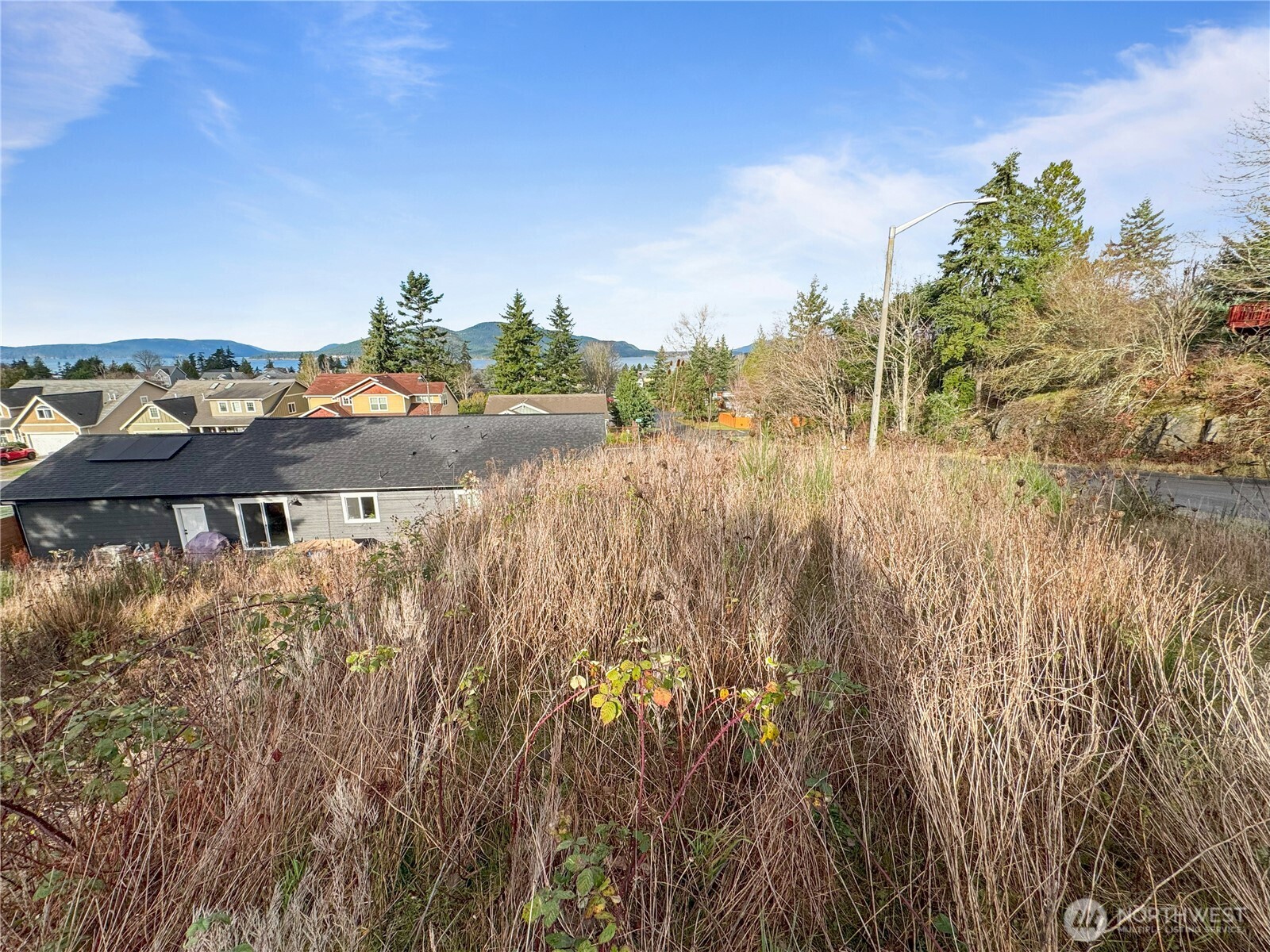 1810 Kansas Avenue Anacortes, WA 98221 - Photo 5 of 8 a view of a lake with houses in back