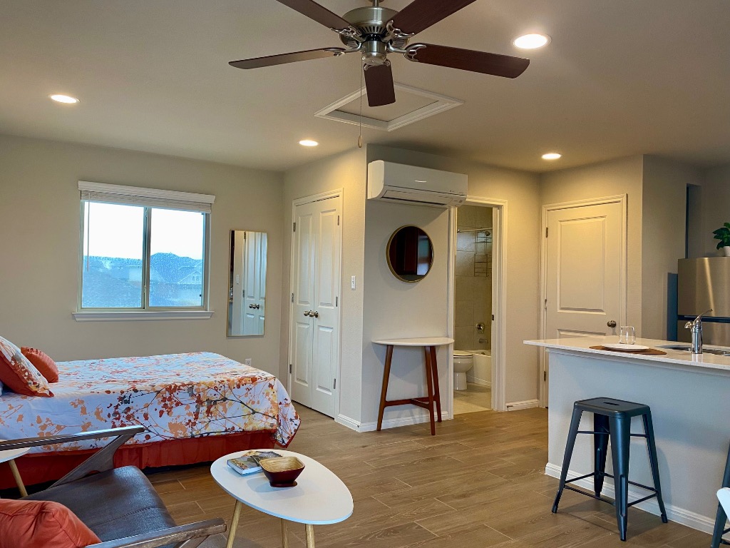 8317 Daisy Cutter Crossing Georgetown, TX 78626 - Photo 1 of 17 a living room with furniture and a flat screen tv