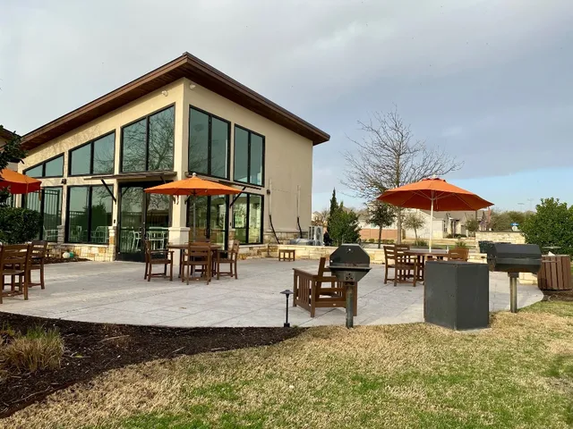 an outdoor space with furniture and umbrella