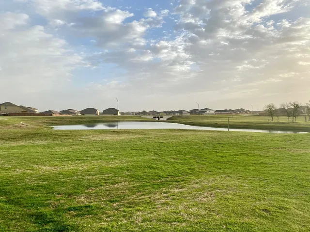 a kitchen with a refrigerator and a sink