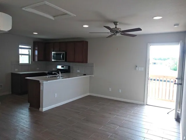 an empty room with closet and windows