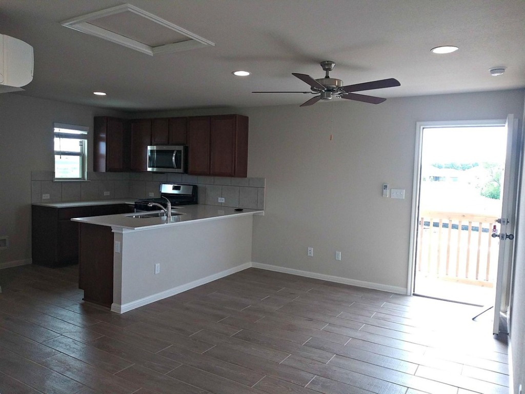 8317 Daisy Cutter Crossing Georgetown, TX 78626 - Photo 16 of 17 a kitchen with a refrigerator and a sink