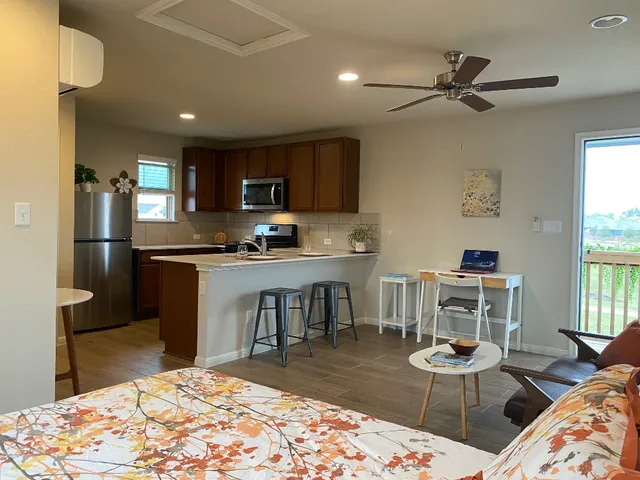 a kitchen with a refrigerator and a stove top oven