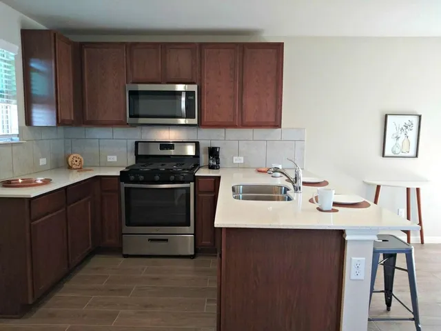 a kitchen with a sink stove and microwave