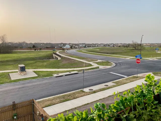 a view of a patio with table and chairs and potted plants
