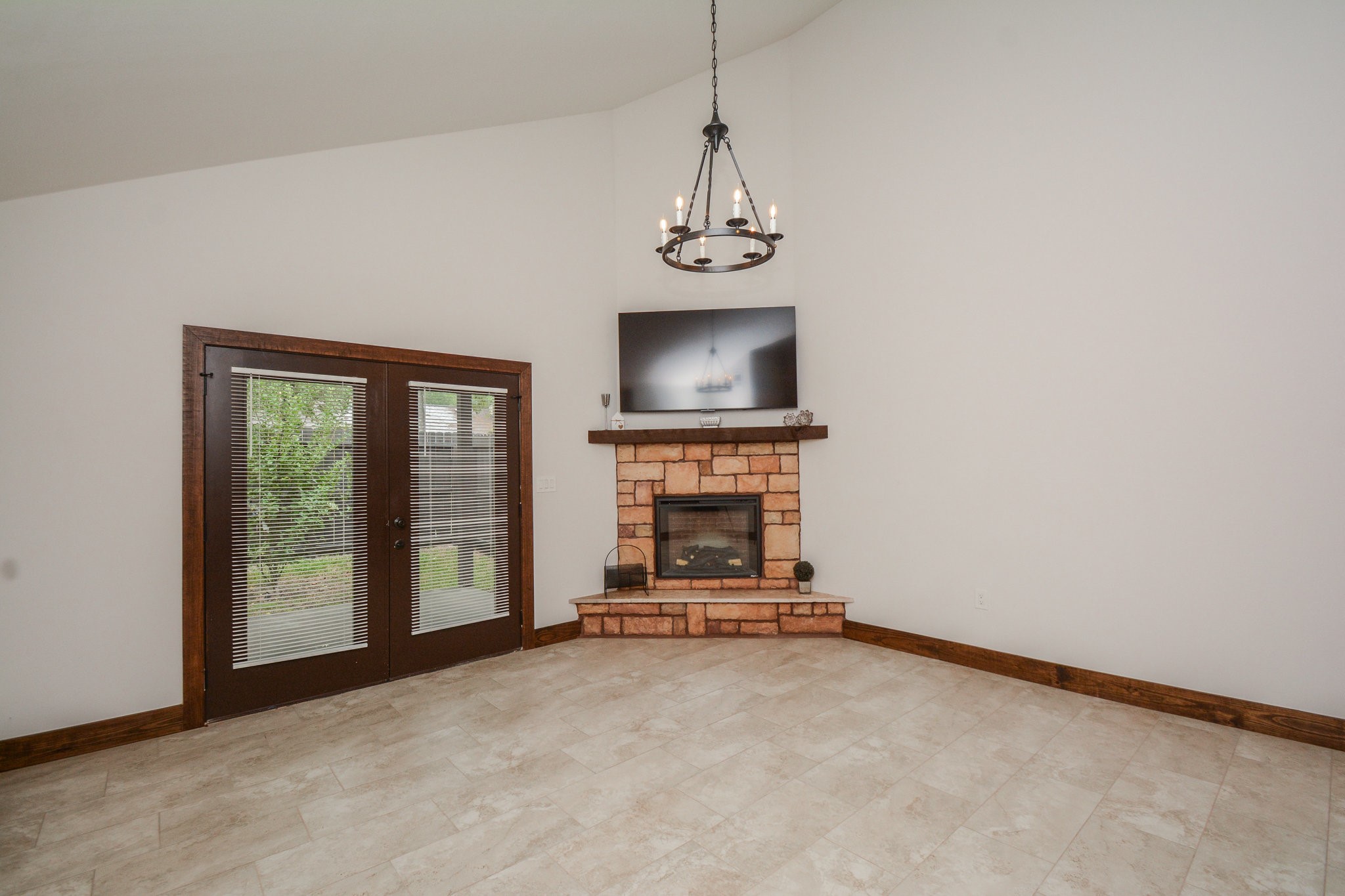 29529 B Turnbury Village Drive Spring, TX 77386 - Photo 18 of 32 a view of a livingroom with a fireplace a ceiling fan and windows