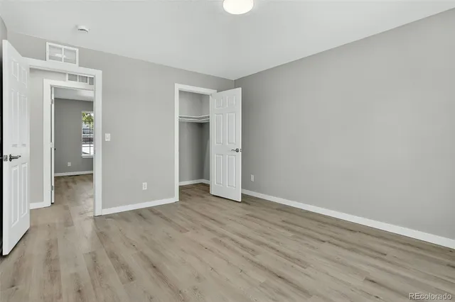 a view of an empty room and wooden floor