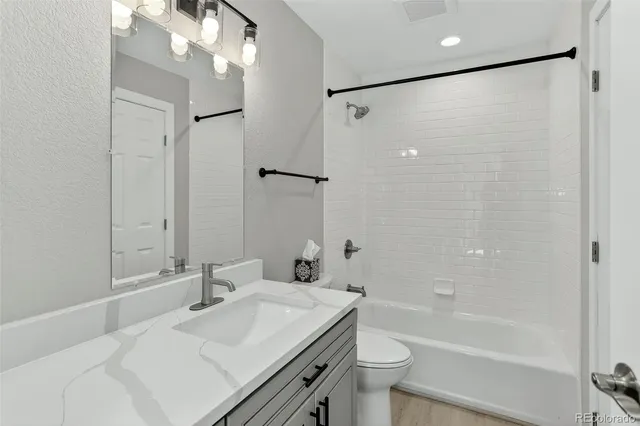 a bathroom with a sink double vanity granite tub shower and a mirror