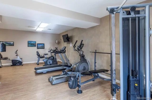 a living room with table chairs and wooden floor
