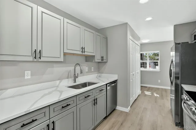 a kitchen with stainless steel appliances granite countertop a sink stove and refrigerator