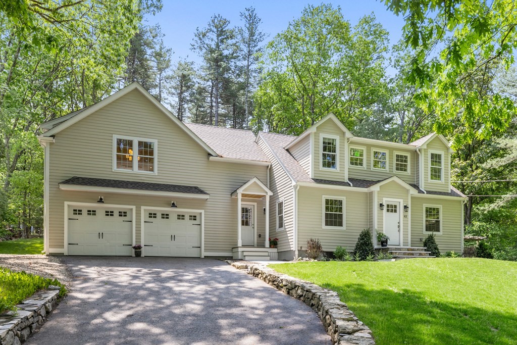 63 Moore Road Wayland, MA 01778 - Photo 36 of 36 a front view of a house with a yard and garage