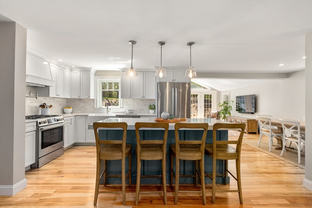 63 Moore Road Wayland, MA 01778 - Photo 6 of 36 a large kitchen with a table and chairs
