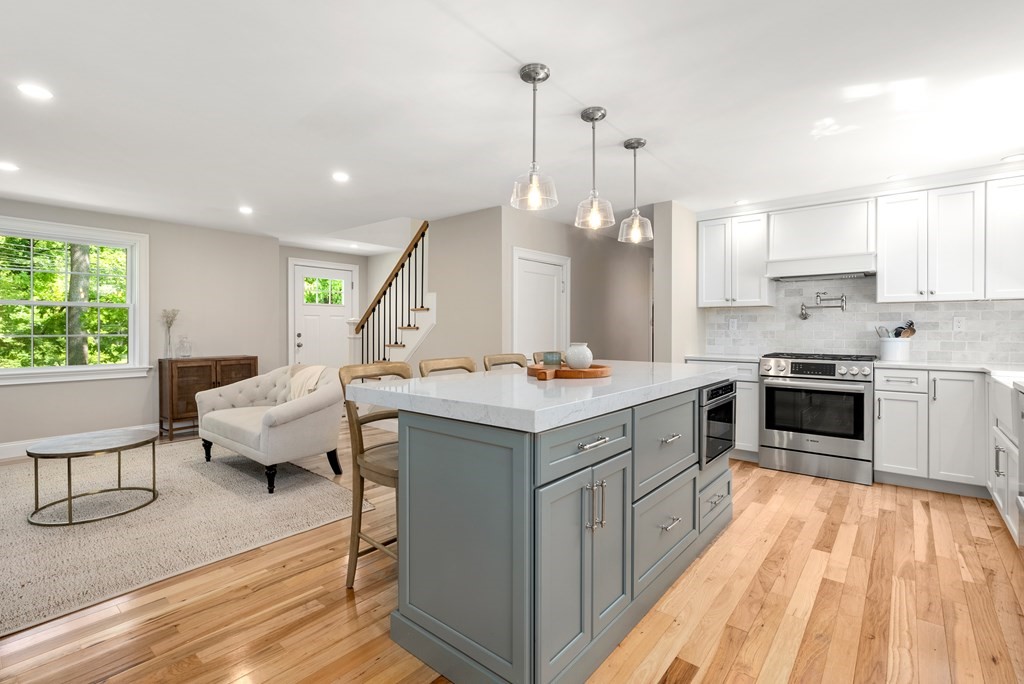 63 Moore Road Wayland, MA 01778 - Photo 8 of 36 a kitchen with a sink stove and wooden floor