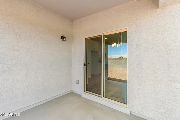 an empty room with sliding glass door