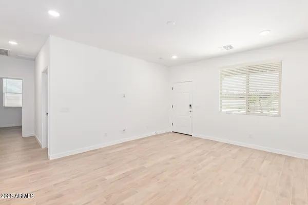 an empty room with wooden floor