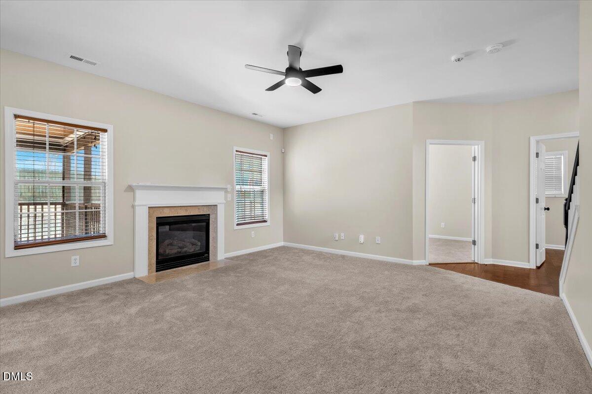 708 Straywhite Avenue Apex, NC 27539 - Photo 15 of 69 a view of an empty room with a fireplace and a window