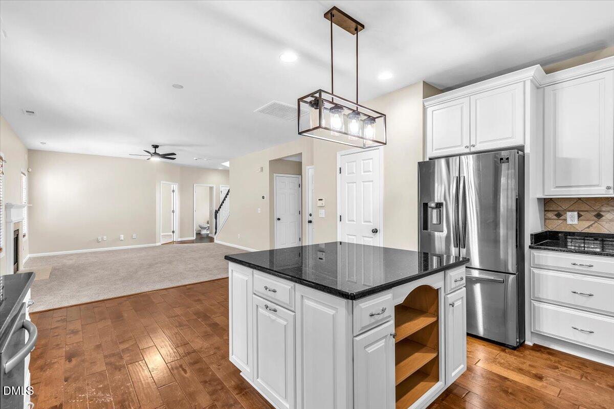 708 Straywhite Avenue Apex, NC 27539 - Photo 22 of 69 a kitchen with stainless steel appliances granite countertop a sink a stove and a refrigerator