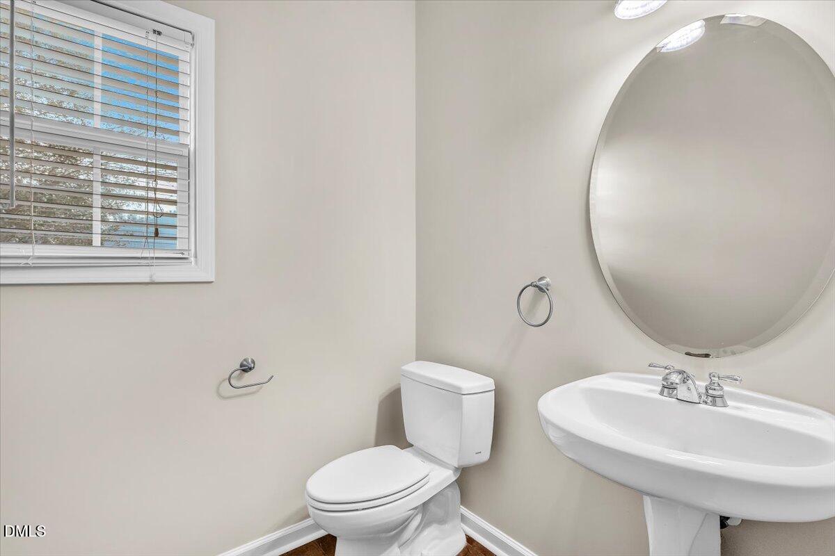 708 Straywhite Avenue Apex, NC 27539 - Photo 29 of 69 a bathroom with a toilet a sink and a mirror