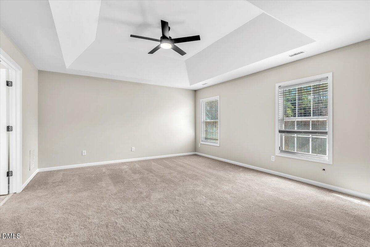 708 Straywhite Avenue Apex, NC 27539 - Photo 30 of 69 an empty room with windows and ceiling fan