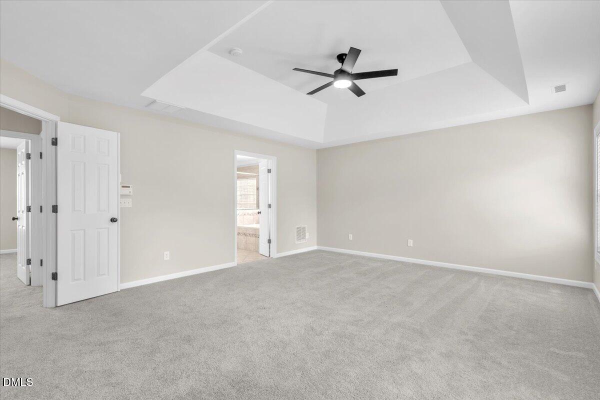 708 Straywhite Avenue Apex, NC 27539 - Photo 31 of 69 a view of an empty room with a ceiling fan