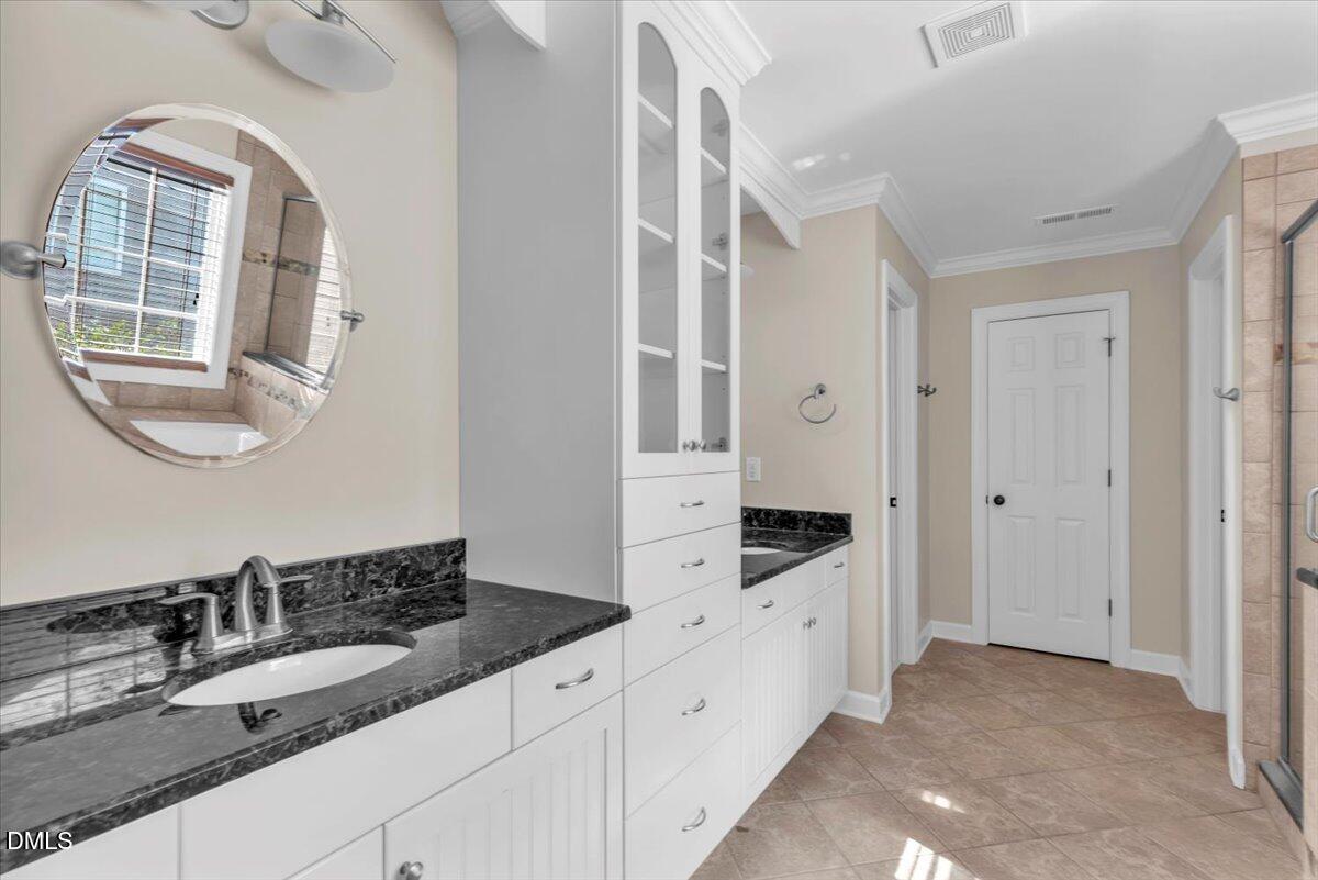 708 Straywhite Avenue Apex, NC 27539 - Photo 35 of 69 a bathroom with a double vanity sink and mirror