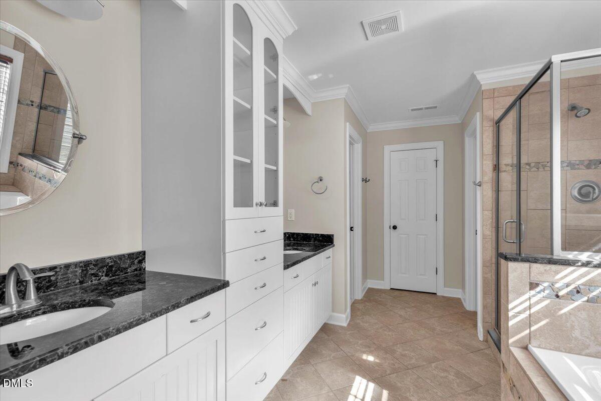 708 Straywhite Avenue Apex, NC 27539 - Photo 36 of 69 a spacious bathroom with a double vanity sink a mirror and a shower