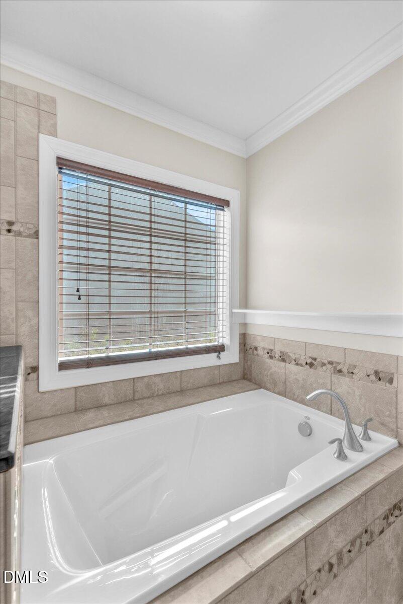 708 Straywhite Avenue Apex, NC 27539 - Photo 43 of 69 a bathroom with a bathtub and next to a window