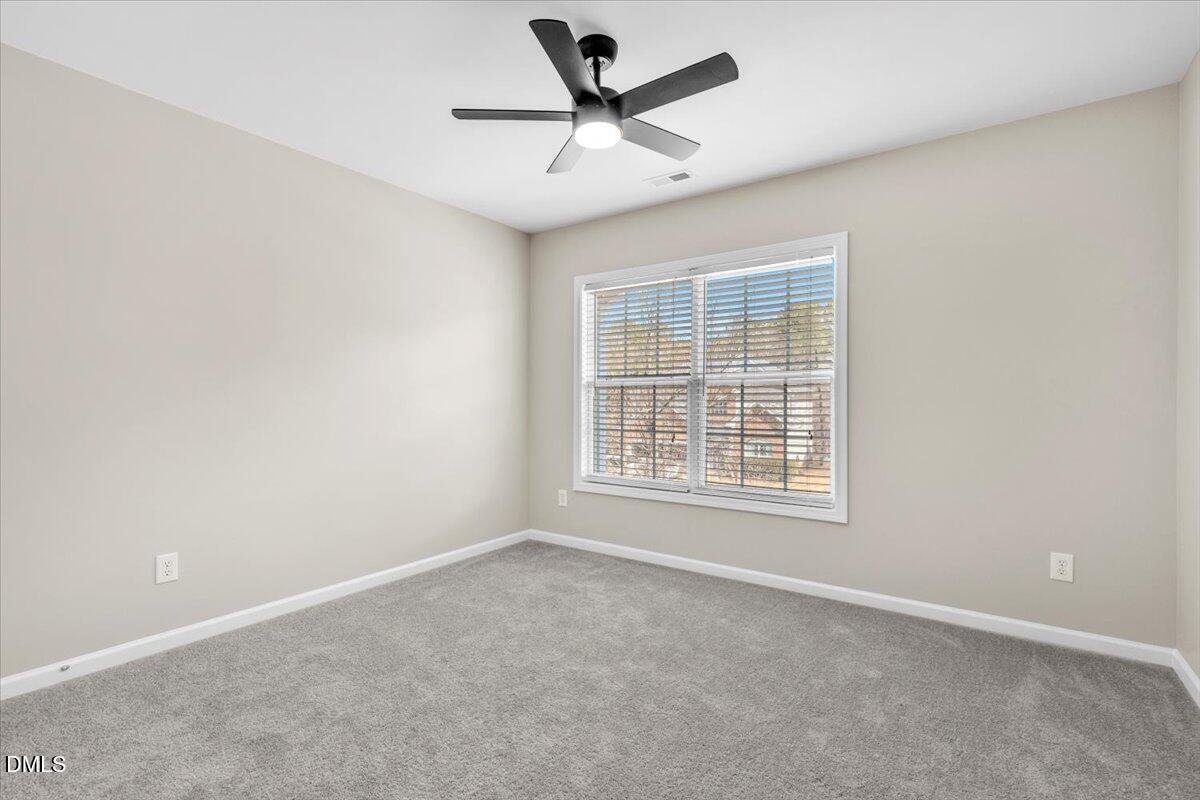 708 Straywhite Avenue Apex, NC 27539 - Photo 45 of 69 an empty room with a window and a fan
