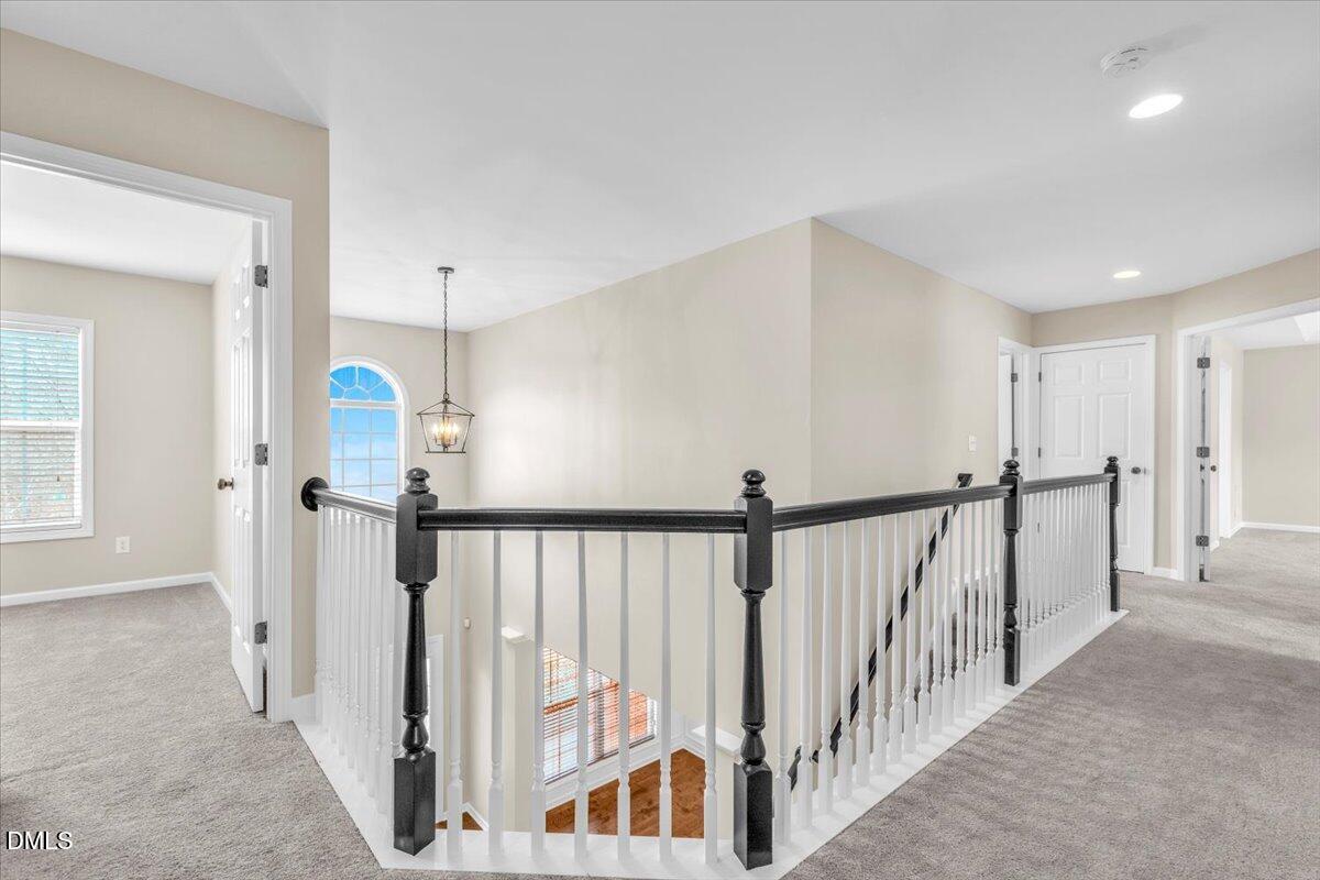 708 Straywhite Avenue Apex, NC 27539 - Photo 50 of 69 a view of a hallway with a white door and stairs
