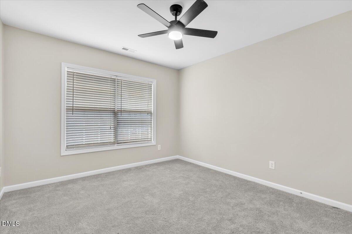 708 Straywhite Avenue Apex, NC 27539 - Photo 51 of 69 a view of a livingroom with a ceiling fan and window
