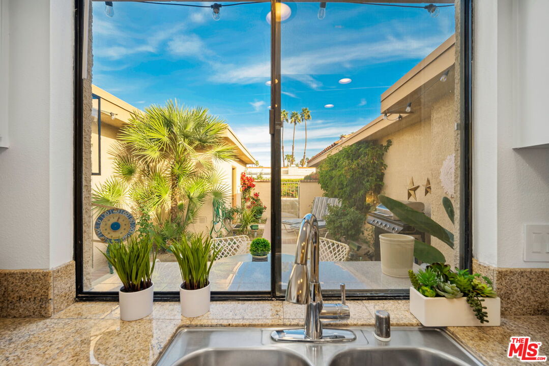 60 La Ronda Drive Rancho Mirage, CA 92270 - Photo 11 of 57 a view of living room with a floor to ceiling window and potted plants