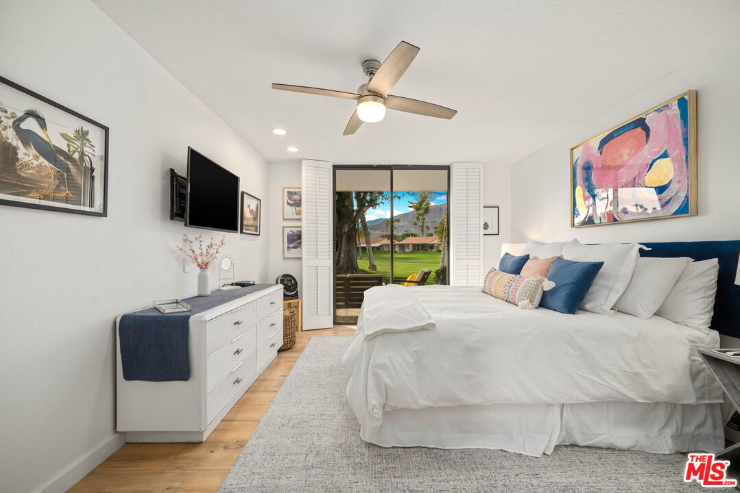 60 La Ronda Drive Rancho Mirage, CA 92270 - Photo 17 of 57 a bedroom with a large bed and a flat screen tv